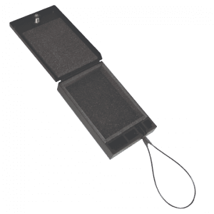 Tuffy portable safe shown open, revealing a foam-lined interior and the attached steel cable extending from the side.