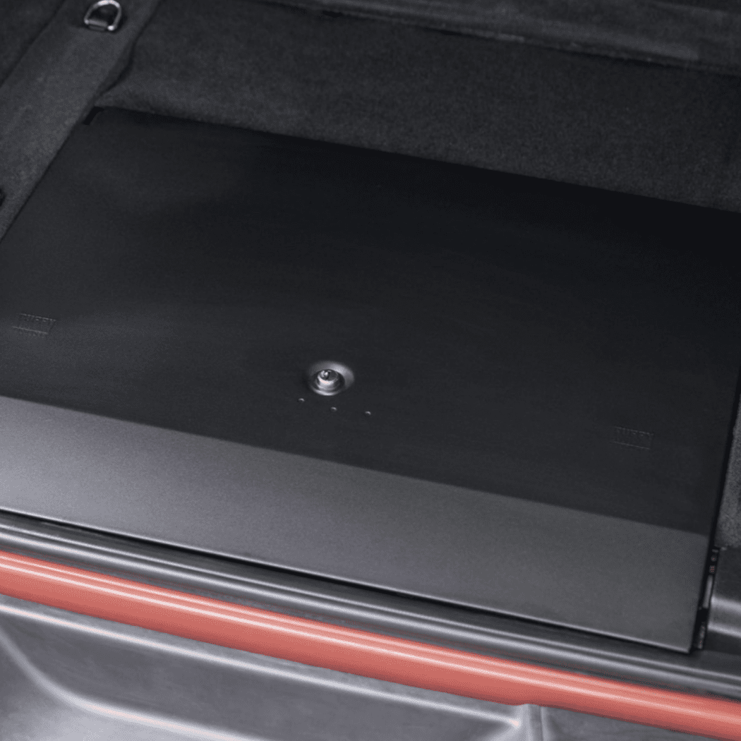 Close-up view of the closed Tuffy Locking Cubby Cover showing the centered keyed lock and durable black powder-coat finish.
