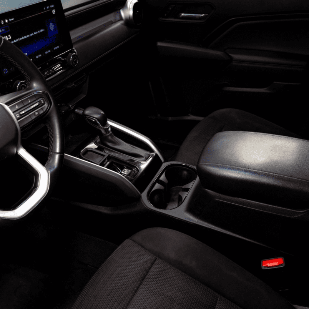 Interior view of a 2023+ GMC Canyon or Chevy Colorado cabin highlighting the center console area equipped with a Tuffy Console Safe.
